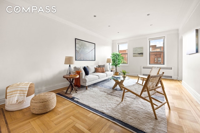 living room featuring radiator, baseboards, and crown molding