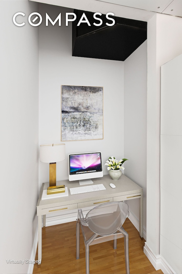 home office with wood finished floors and baseboards