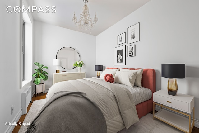 bedroom with radiator heating unit, a chandelier, and wood finished floors