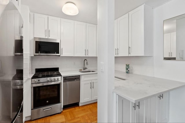 230 E 15th St Unit 3A, New York City, NY 10003 - kitchen with stainless steel appliances, a sink, and white cabinetry