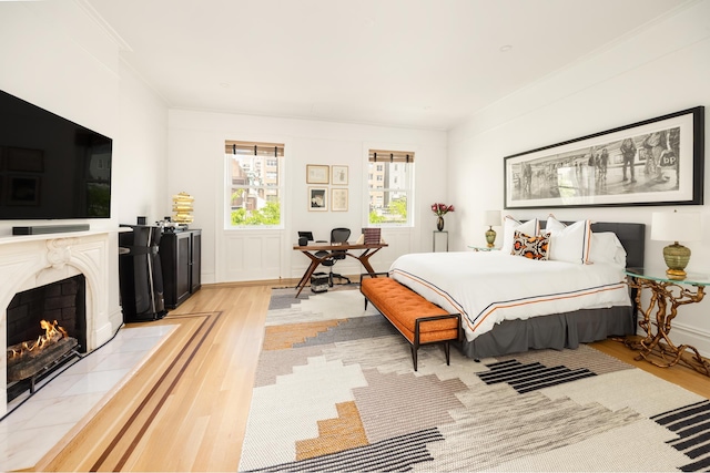 116 E 65th St, New York City, NY 10065 - bedroom featuring light wood-type flooring, a fireplace, and crown molding