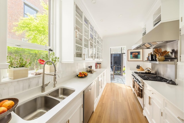 116 E 65th St, New York City, NY 10065 - kitchen featuring stainless steel appliances, white cabinets, light countertops, and healthy amount of natural light