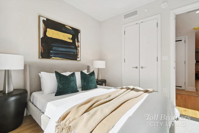 bedroom featuring wood finished floors and a closet