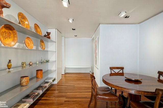 dining space with wood finished floors