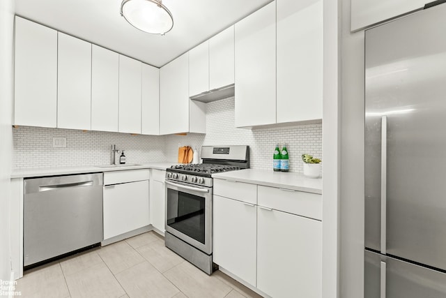 245 E 25th St Unit 5A, New York City, NY 10010 - kitchen with appliances with stainless steel finishes, light countertops, tasteful backsplash, and white cabinets