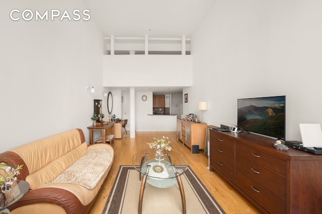 77 Bleecker St Unit 618, New York City, NY 10012 - living room featuring light wood finished floors and a high ceiling