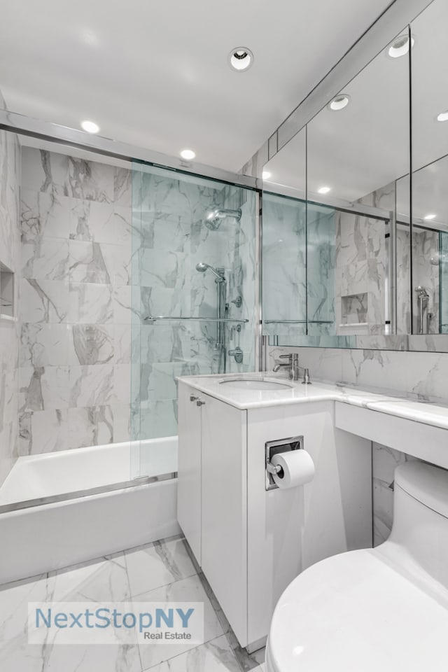 400 E 56th St Unit 25S, New York City, NY 10022 - full bath featuring toilet, recessed lighting, combined bath / shower with glass door, vanity, and marble finish flooring