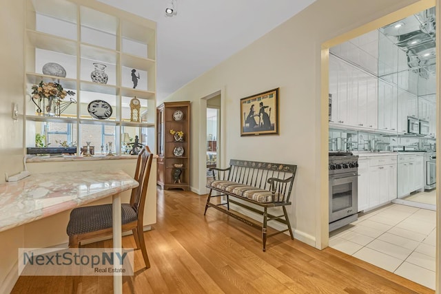 400 E 56th St Unit 25S, New York City, NY 10022 - dining area featuring light wood-type flooring and baseboards
