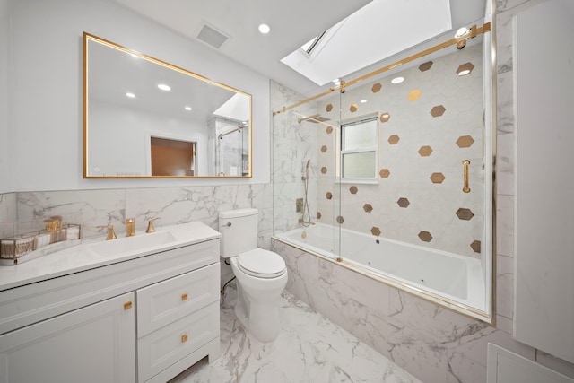 173-73 Croydon Rd, New York City, NY 11432 - full bath featuring a skylight, vanity, shower / bath combination with glass door, marble tiled floors, and tile walls