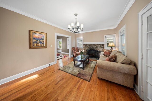 173-73 Croydon Rd, New York City, NY 11432 - living room with a chandelier, a fireplace, baseboards, light wood-style floors, and ornamental molding