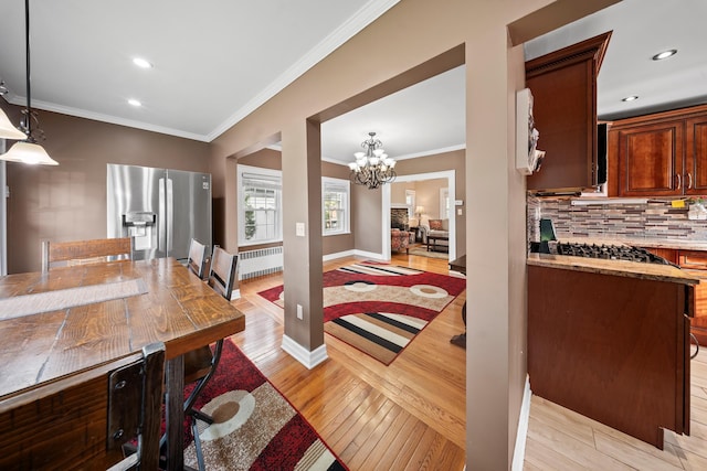 173-73 Croydon Rd, New York City, NY 11432 - dining area with light wood finished floors, radiator heating unit, a chandelier, ornamental molding, and recessed lighting