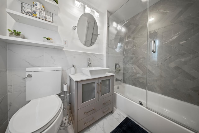 173-73 Croydon Rd, New York City, NY 11432 - full bath featuring toilet, tile walls, vanity, enclosed tub / shower combo, and marble finish flooring