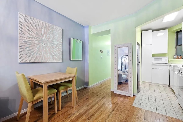 226 E 95th St Unit 201, New York City, NY 10128 - dining area featuring light wood-style flooring and baseboards