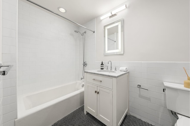 481 Macon St, New York City, NY 11233 - full bathroom featuring toilet, shower / bathtub combination, tile patterned flooring, vanity, and tile walls