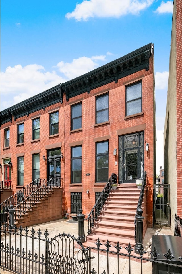 481 Macon St, New York City, NY 11233 - view of front of property featuring a fenced front yard and brick siding