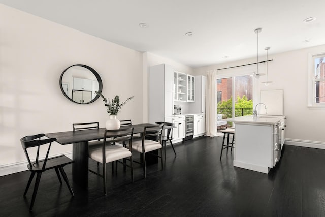 481 Macon St, New York City, NY 11233 - dining area featuring beverage cooler, baseboards, plenty of natural light, dark wood-style floors, and recessed lighting