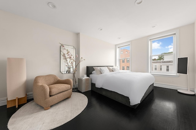 481 Macon St, New York City, NY 11233 - bedroom featuring baseboards, dark wood finished floors, recessed lighting, and baseboard heating
