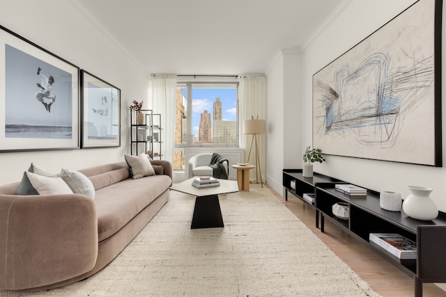 living area featuring ornamental molding and wood finished floors