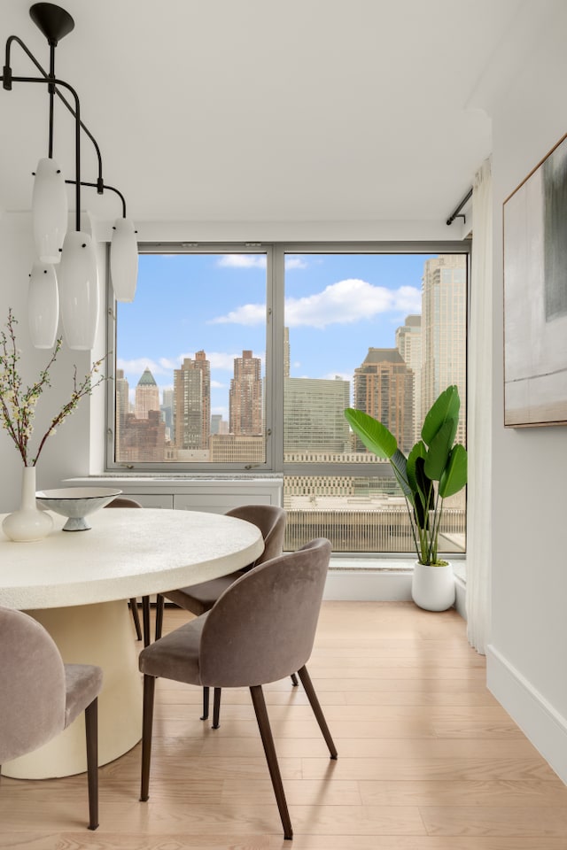 1965 Broadway Unit 20A, New York City, NY 10023 - dining space with a skyline view and wood finished floors