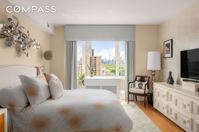 bedroom featuring light wood-style floors
