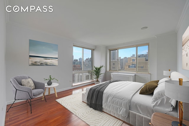 201 E 80th St Unit 16D, New York City, NY 10075 - bedroom with crown molding, a view of skyline, wood finished floors, and baseboards