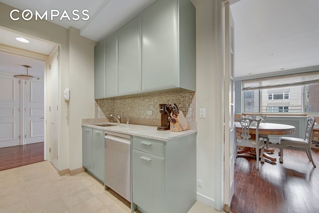 201 E 80th St Unit 16D, New York City, NY 10075 - kitchen with dishwasher, a sink, light countertops, backsplash, and gray cabinets