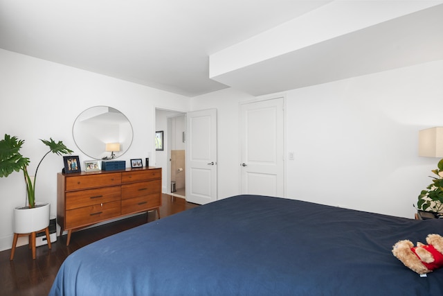 bedroom featuring dark wood finished floors
