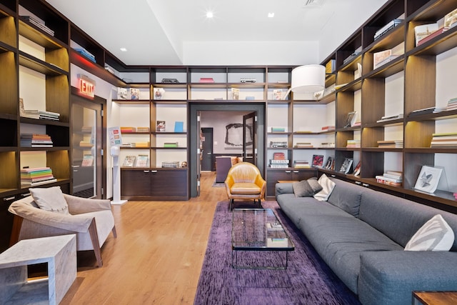 living room featuring light wood-type flooring and recessed lighting