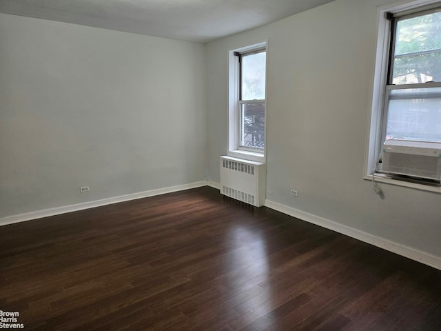 67-12 Yellowstone Blvd Unit C12, New York City, NY 11375 - empty room featuring radiator, dark wood-style floors, baseboards, and cooling unit