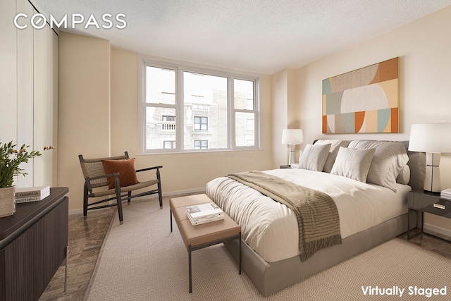 bedroom with baseboards and a textured ceiling