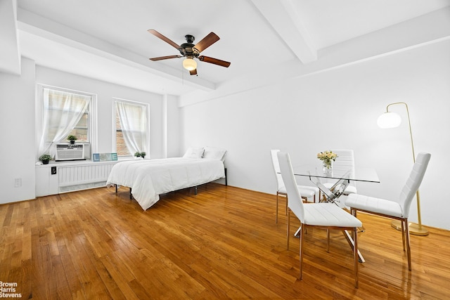 310 Riverside Dr Unit 1201, New York City, NY 10025 - bedroom with beam ceiling, radiator heating unit, wood finished floors, and ceiling fan