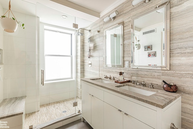 165 W 91st St Unit 11E, New York City, NY 10025 - full bathroom with a shower stall, double vanity, ornamental molding, and tile walls
