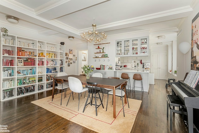 dining space featuring ornamental molding, dark wood-type flooring, and a chandelier