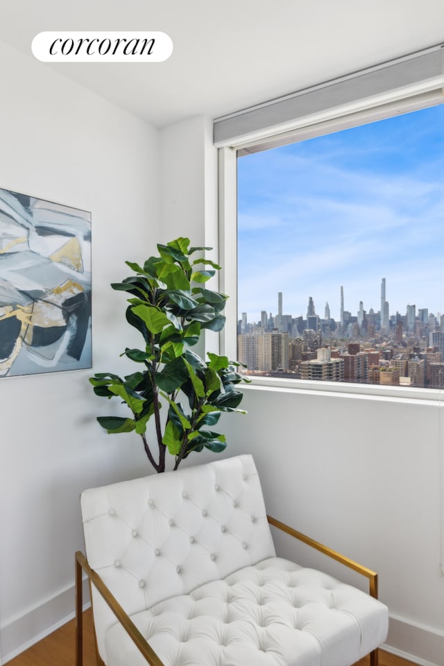2628 Broadway Unit 34A, New York City, NY 10025 - living area with a view of skyline, baseboards, and wood finished floors