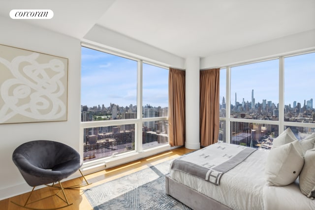 2628 Broadway Unit 34A, New York City, NY 10025 - bedroom featuring a skyline view, wood finished floors, and multiple windows