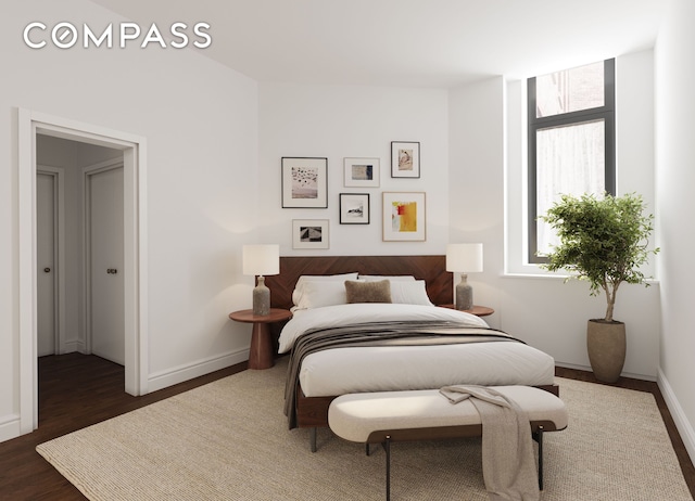 bedroom with baseboards and dark wood finished floors