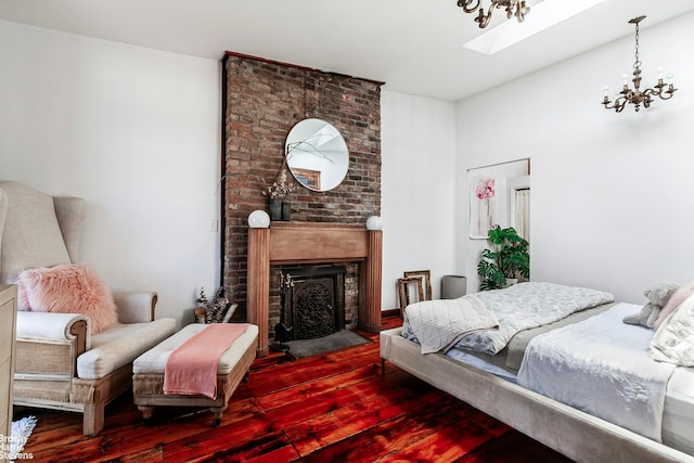 301 Water St, New York City, NY 11201 - bedroom with hardwood / wood-style flooring, a fireplace, a skylight, and a chandelier
