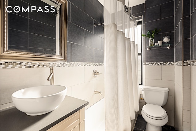 315 E 80th St Unit 2J, New York City, NY 10075 - bathroom with tile walls, a shower with curtain, and vanity