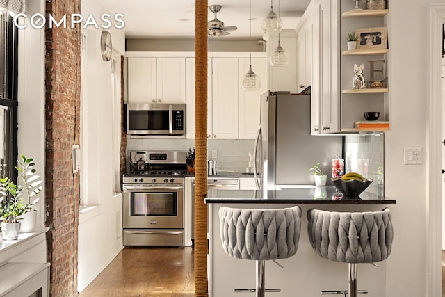 315 E 80th St Unit 2J, New York City, NY 10075 - kitchen with appliances with stainless steel finishes, open shelves, and decorative backsplash