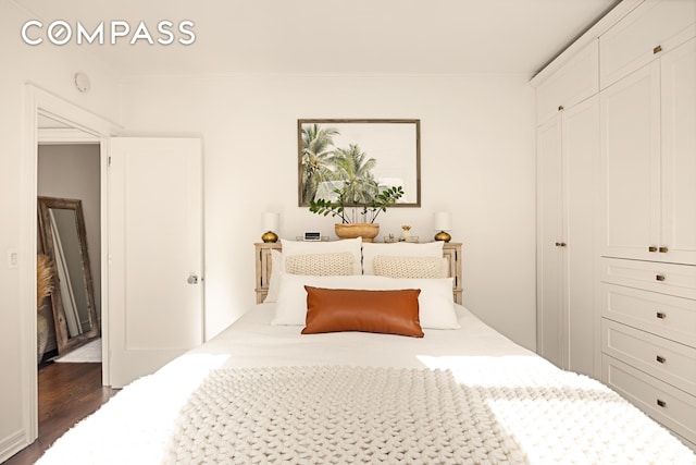 315 E 80th St Unit 2J, New York City, NY 10075 - bedroom featuring ornamental molding and dark wood finished floors