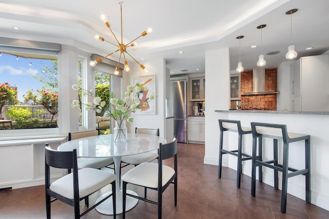 dining room featuring a chandelier, recessed lighting, dark tile patterned floors, and baseboards