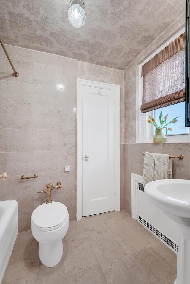 434 E 52nd St Unit 6Ab, New York City, NY 10022 - bathroom featuring tile walls and marble finish flooring