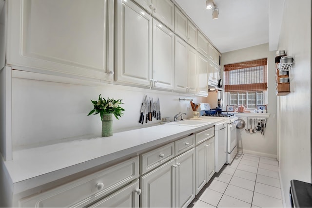 434 E 52nd St Unit 6Ab, New York City, NY 10022 - kitchen featuring white range with gas cooktop, a sink, light countertops, and light tile patterned floors