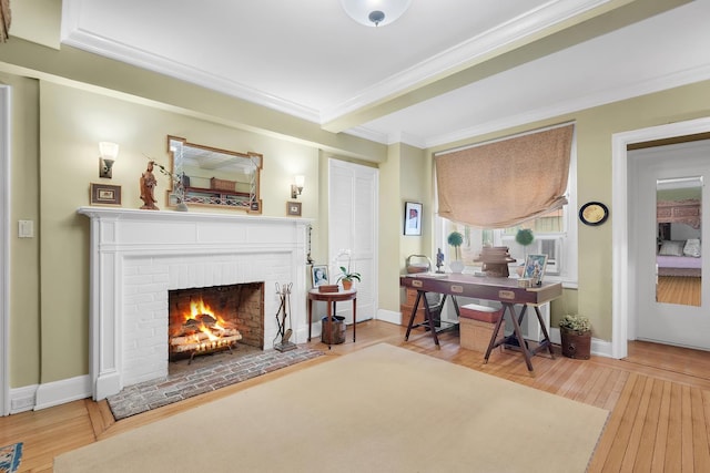 434 E 52nd St Unit 6Ab, New York City, NY 10022 - living area with hardwood / wood-style floors, a fireplace, ornamental molding, a desk, and baseboards