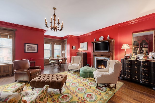 330 Convent Ave, New York City, NY 10031 - living area featuring a chandelier, ornamental molding, wood finished floors, and a lit fireplace