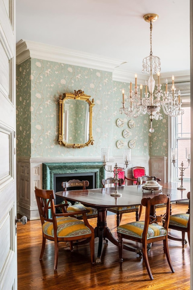 330 Convent Ave, New York City, NY 10031 - dining space featuring wallpapered walls, ornamental molding, a chandelier, wainscoting, and a fireplace