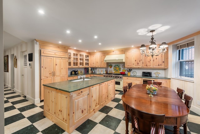 330 Convent Ave, New York City, NY 10031 - kitchen featuring under cabinet range hood, dark countertops, high end stainless steel range, light flooring, and recessed lighting