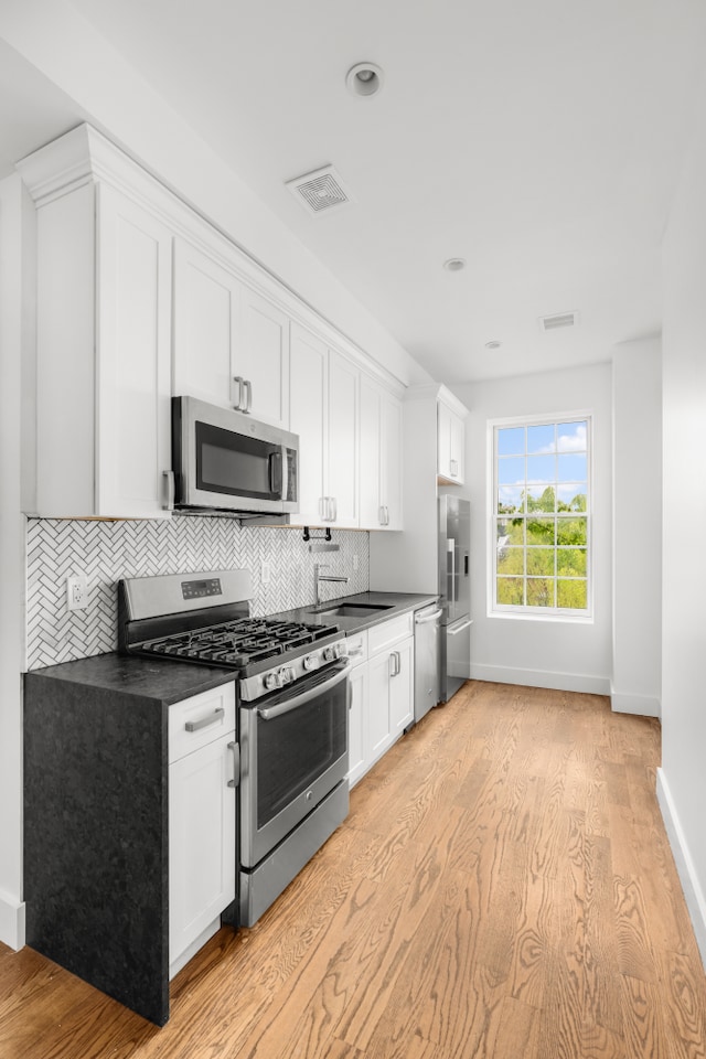 935 Lafayette Ave Unit 4, New York City, NY 11221 - kitchen featuring stainless steel appliances, dark countertops, baseboards, and recessed lighting