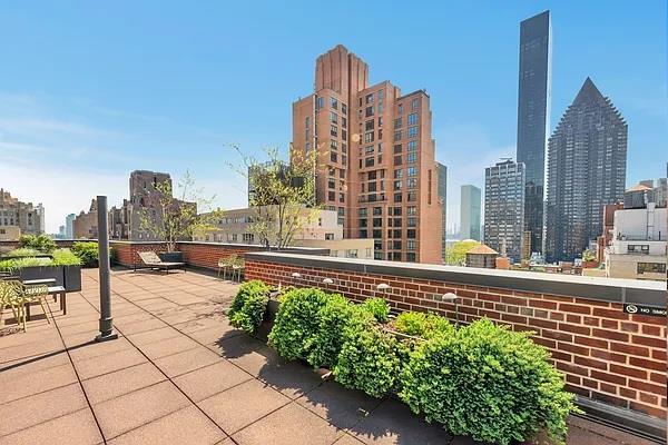 345 E 52nd St Unit 11D, New York City, NY 10022 - view of patio with a skyline view