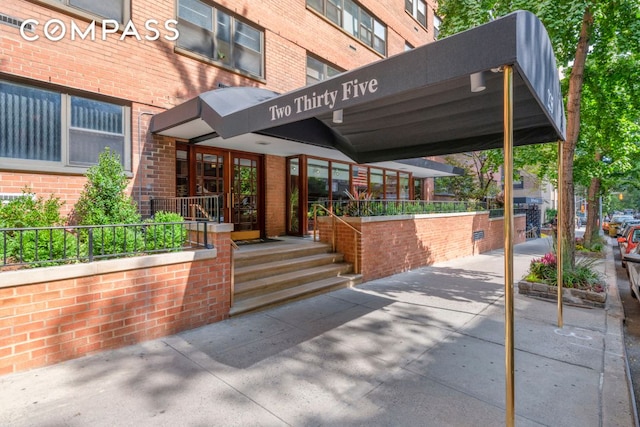 property entrance with brick siding